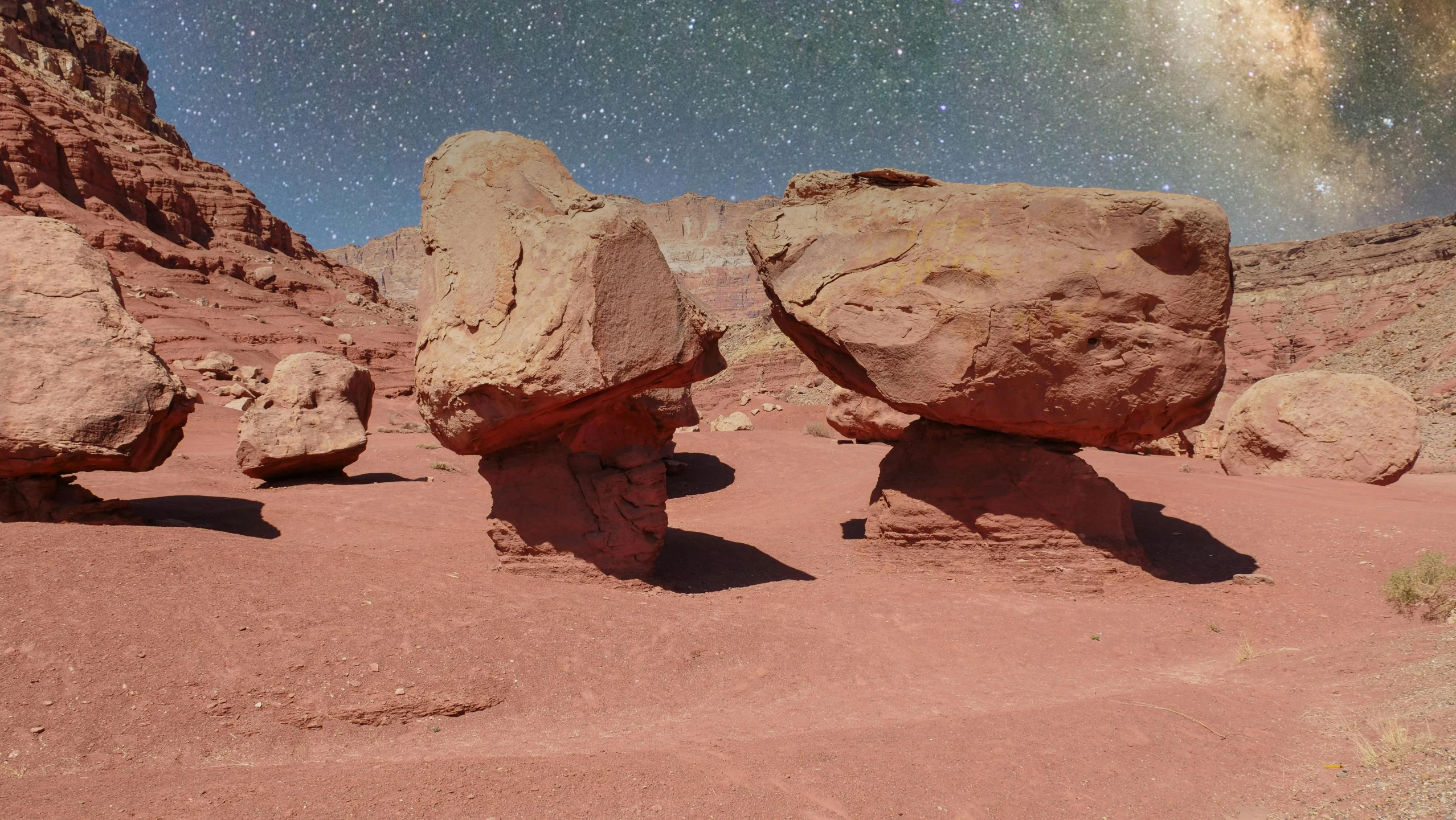 a group of rocks sitting in the middle of a desert, inspired by Filip Hodas, unsplash contest winner, red sandstone natural sculptures, portal to outer space, projection mapping, jessica rossier and brian froud