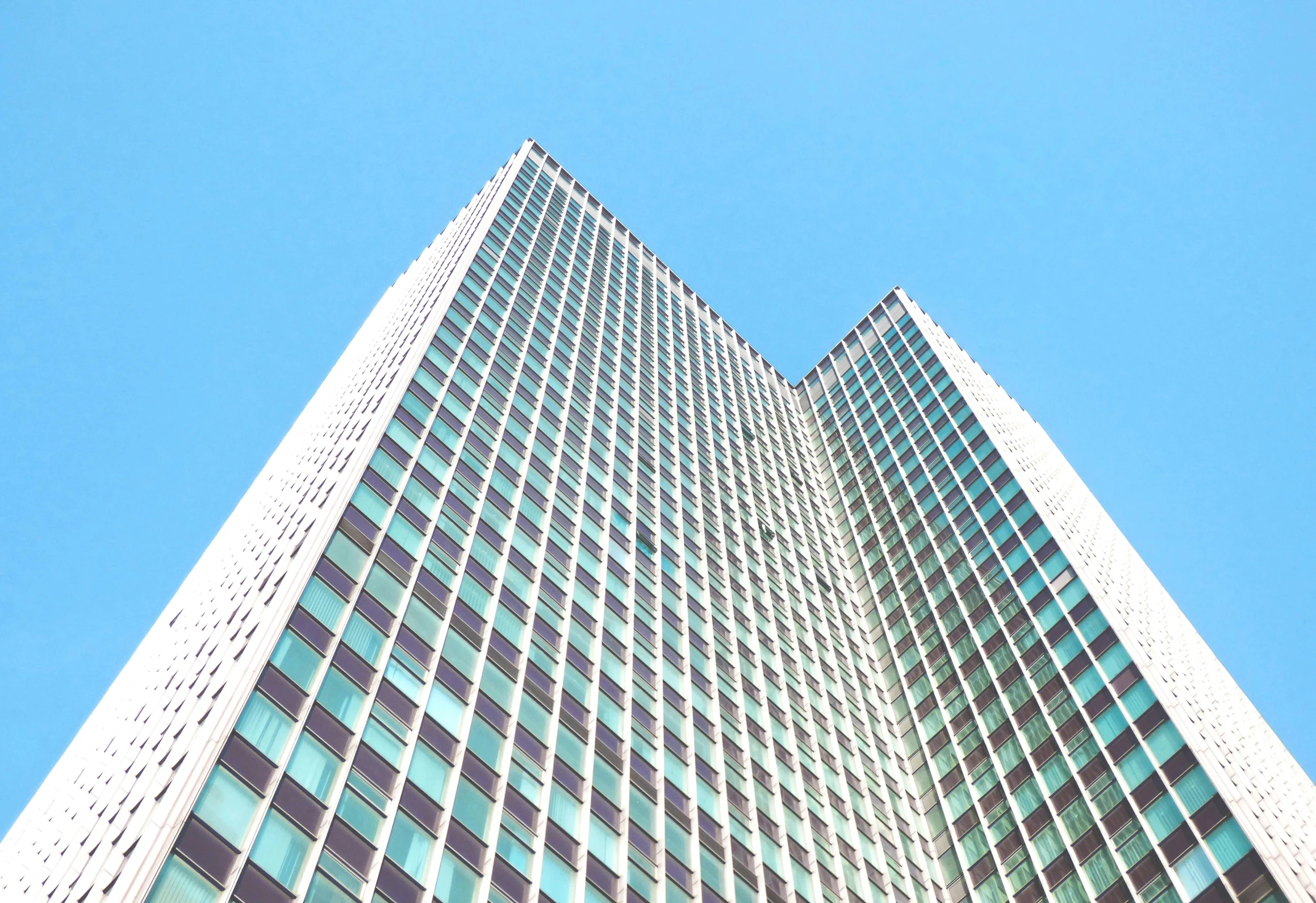 a tall building with a blue sky in the background, by Yasushi Sugiyama, retro architecture, canary wharf, aquamarine windows, ultra - quality