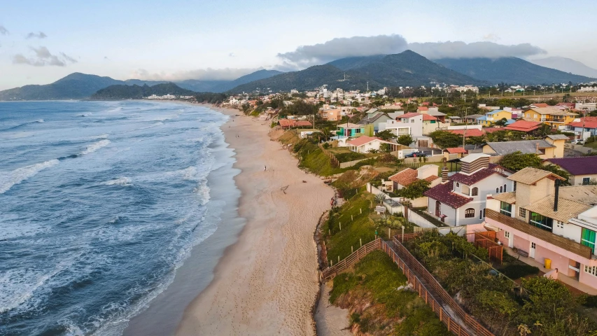 a beach with houses and mountains in the background, by Luis Miranda, pexels contest winner, renaissance, aerial footage, henrique alvim corrêa, avatar image, multiple stories