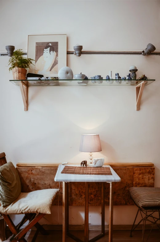 a small table with a lamp on top of it, a portrait, inspired by Constantin Hansen, unsplash, light and space, cafe for felted animals, shelves, handmade pottery, sitting in a lounge