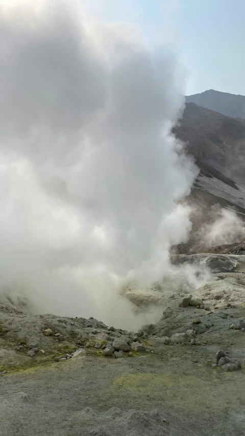 a group of people standing on top of a mountain, green steam rising from soup, ap news, vulcano, slide show