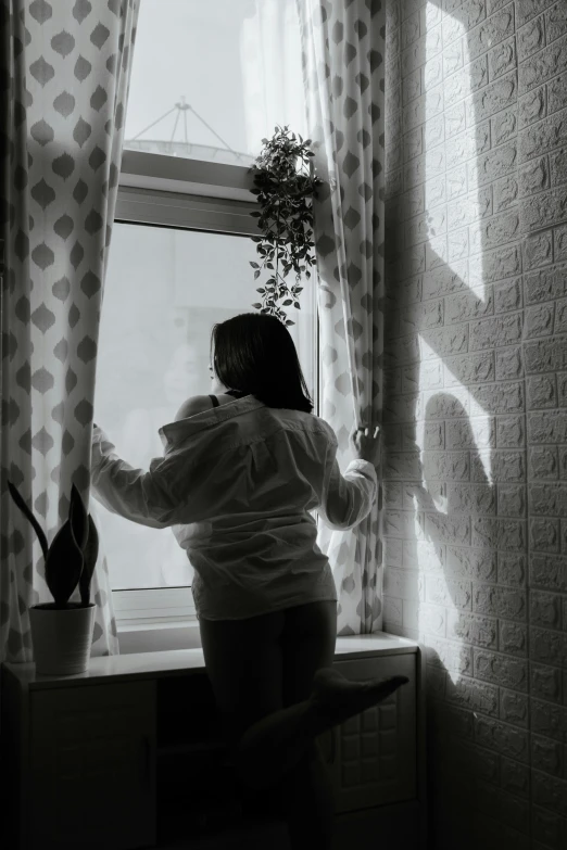 a black and white photo of a woman looking out a window, a black and white photo, inspired by Elsa Bleda, pexels contest winner, magical realism, spring evening, full body backlight, snapchat photo, ilustration