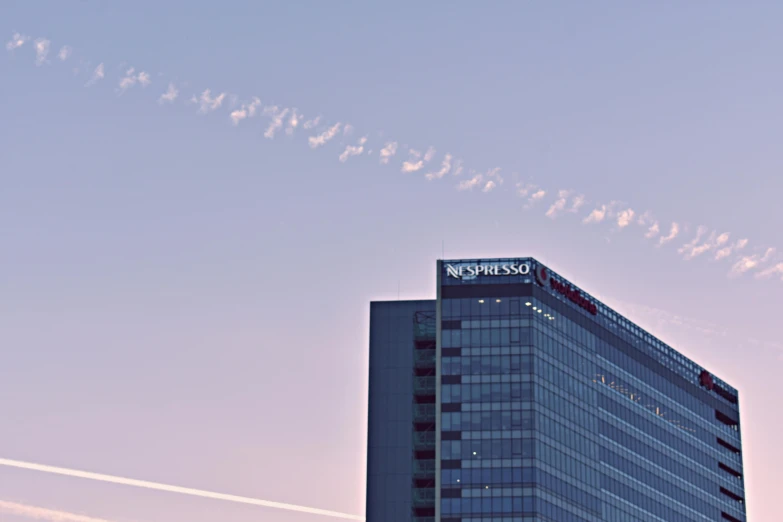 there is a plane that is flying in the sky, inspired by Edward Ruscha, unsplash, office building, wideshot, morning detail, panspermia