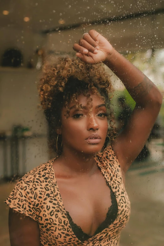 a woman standing under an umbrella in the rain, an album cover, trending on pexels, renaissance, with brown skin, with curls, shot at golden hour, looking serious