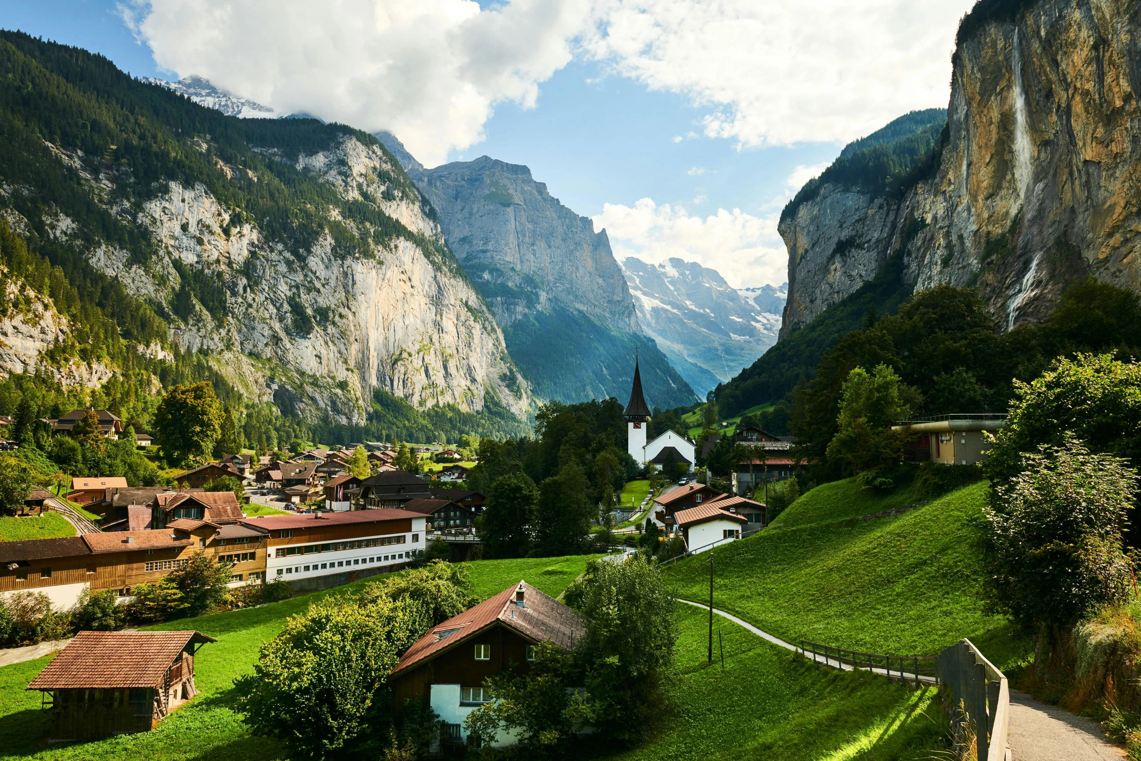 a scenic view of a village in the mountains, inspired by Karl Stauffer-Bern, pexels contest winner, lush green, tall stone spires, tie-dye, conde nast traveler photo