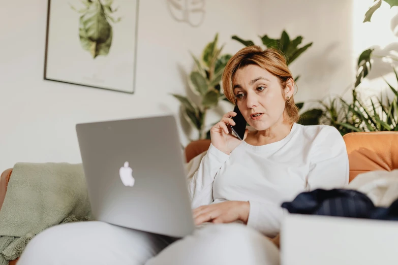 a woman sitting on a couch talking on a cell phone, trending on pexels, happening, sitting at a computer, someone sits in bed, avatar image, maintenance