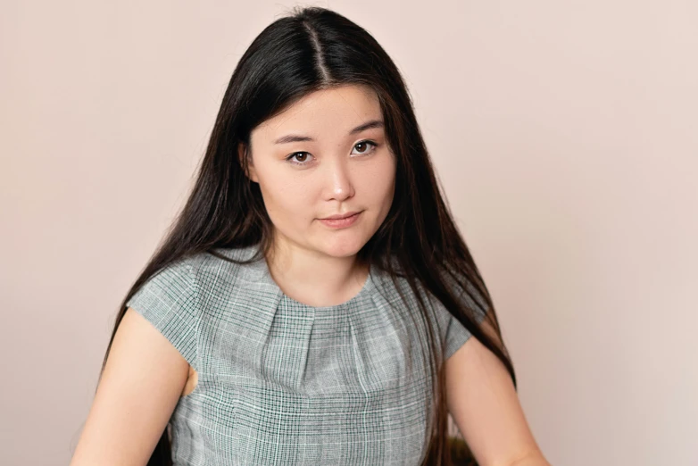 a woman sitting at a table with a plate of food, darren quach, profile image, on grey background, slightly round chin