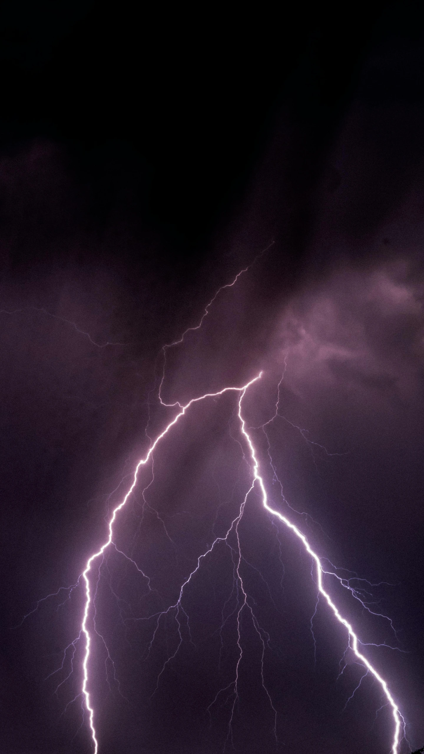 a lightning bolt hitting through a dark sky, by Andries Stock, trending on pexels, mikko lagerstedt, purple. ambient lightning, high quality photo, electricity archs