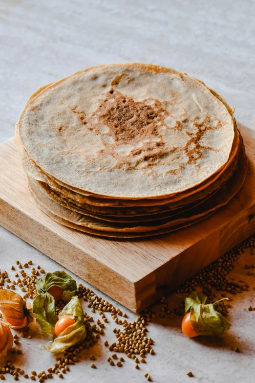 a stack of tortillas sitting on top of a cutting board, renaissance, detailed product image, spices, dessert, mead