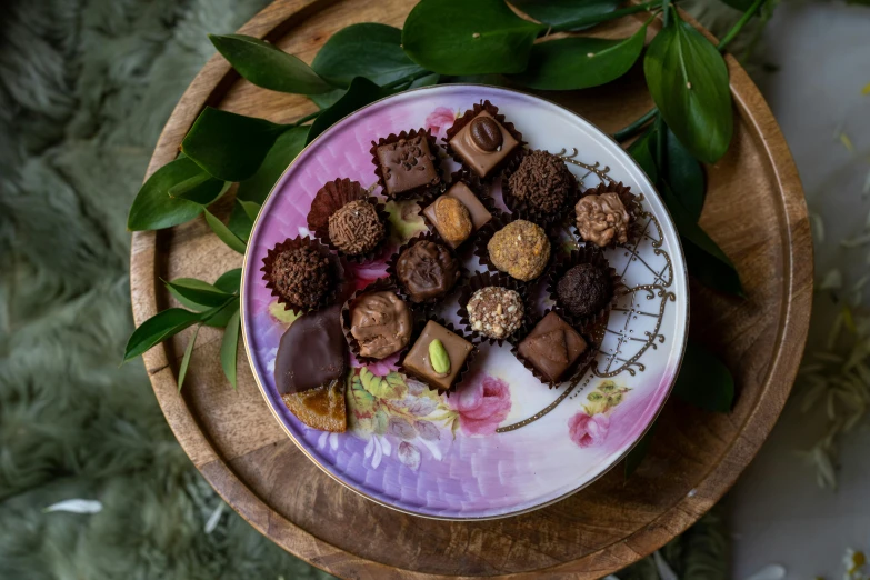 a close up of a plate of chocolates on a table, by Anna Findlay, botanicals, romantic lead, moroccan, thumbnail