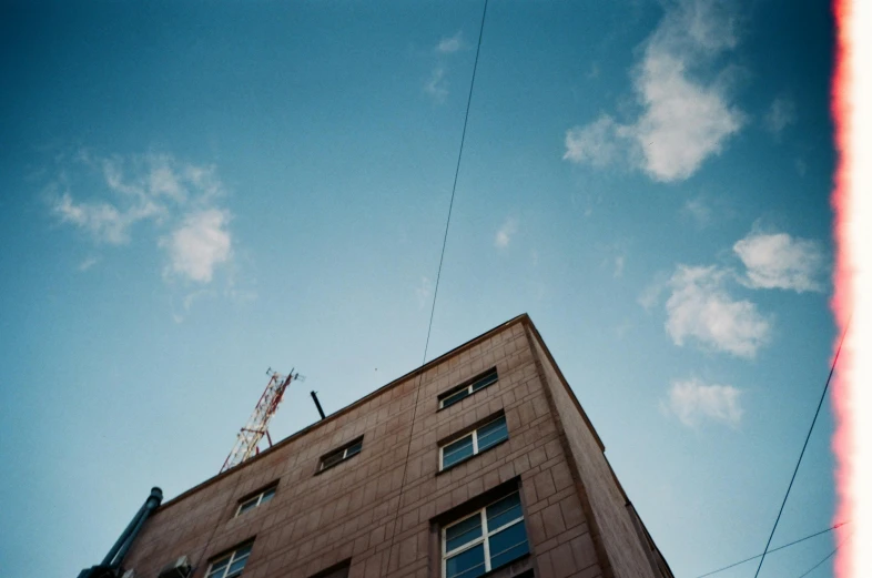 a tall building with a clock on top of it, an album cover, by Carl Hoppe, unsplash, postminimalism, telephone wires, photo taken on fujifilm superia, ignant, post - soviet courtyard