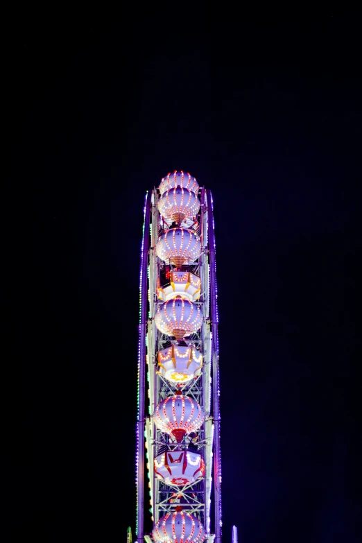 a ferris wheel is lit up at night, a picture, by Konrad Witz, stacked image, purple, 2 0 0 mm telephoto, multicolored