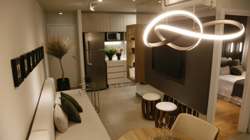 a living room filled with furniture and a flat screen tv, by Felipe Seade, unsplash, light and space, in sao paulo, white neon lighting, maxwell boas, dark and beige atmosphere