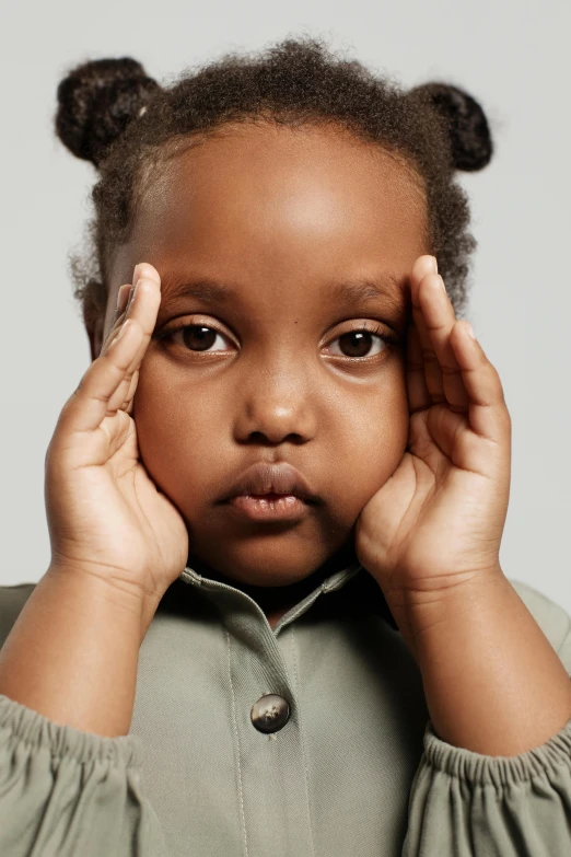 a little girl holding her hands to her face, an album cover, shutterstock contest winner, brown skinned, concerned expression, 2 years old, thinker pose