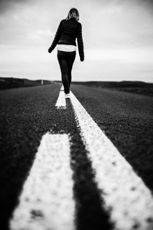 a woman walking down the middle of a road, a black and white photo, happening, sport, !!!!!!!!!!!!!!!!!!!!!!!!!, iron and asphalt, profile image