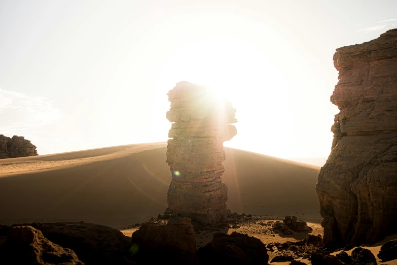 a rock formation in the middle of a desert, by Andrei Kolkoutine, unsplash contest winner, land art, sun flares, totem pole, chile, taken in the early 2020s