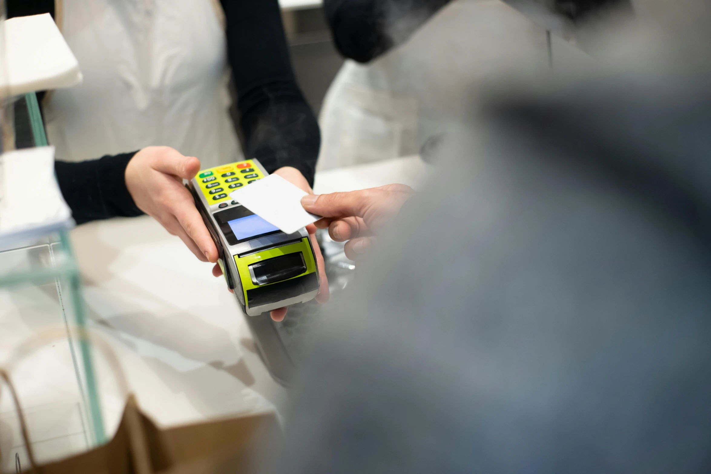 a close up of a person holding a cell phone, at checkout, square, high-quality photo, swedish