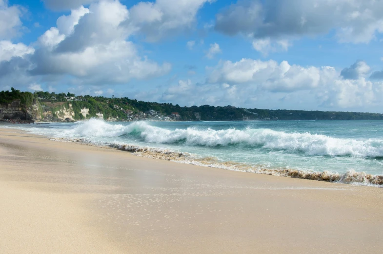 a large body of water sitting on top of a sandy beach, by Thomas Baines, pexels contest winner, bali, roaring ocean in front, panorama, avatar image