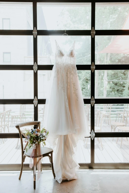 a wedding dress hanging in front of a window, botanicals, ethereal lighting - h 640, exterior, vanilla