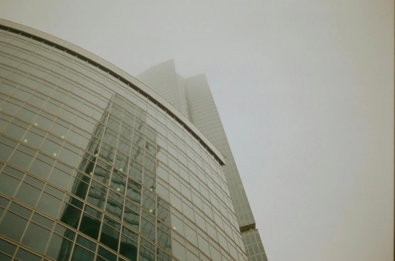 a tall building sitting in the middle of a foggy sky, glass ceilings, moscow, documentary photo, taken with sony alpha 9