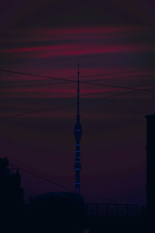 a very tall tower sitting in the middle of a city, inspired by Elsa Bleda, pexels contest winner, postminimalism, barely lit warm violet red light, radio signals, moscow, purple and black