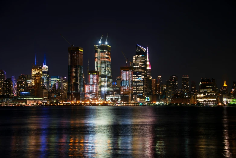 the city skyline is lit up at night, by Julia Pishtar, unsplash photography, peter hurley, shoreline, ilustration