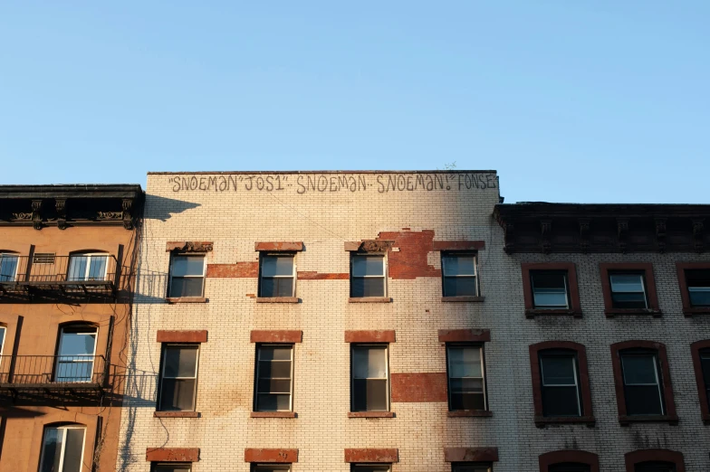 a couple of buildings that are next to each other, inspired by Joel Shapiro, unsplash, graffiti, schomburg, golden hour photograph, ignant, stephen shore