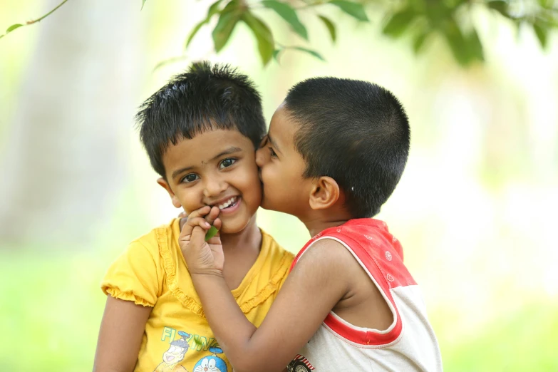 a couple of kids standing next to each other, by Max Dauthendey, pexels contest winner, hurufiyya, kissing smile, avatar image, nivanh chanthara, thumbnail