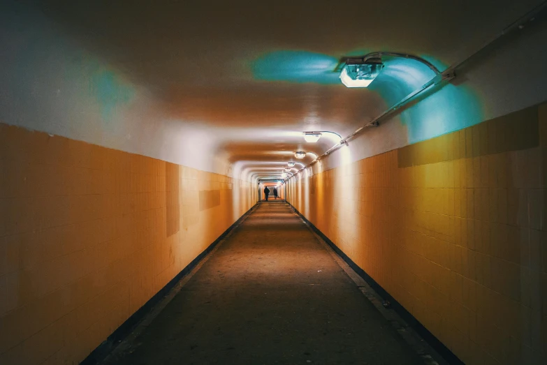 a long hallway with a light at the end of it, unsplash contest winner, graffiti, yellow artificial lighting, orange teal lighting, cardboard tunnels, instagram photo