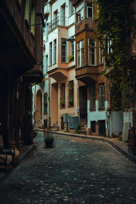 a cobblestone street in an old european city, inspired by Elsa Bleda, pexels contest winner, fallout style istanbul, beige, square, apartments