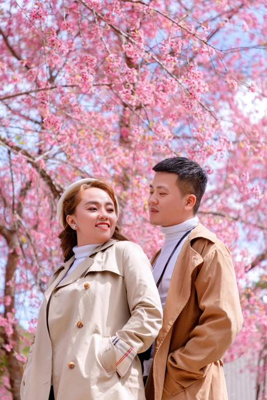 a man and a woman standing next to each other, by Tan Ting-pho, pexels contest winner, lush sakura, jacket, mai anh tran, taiwan