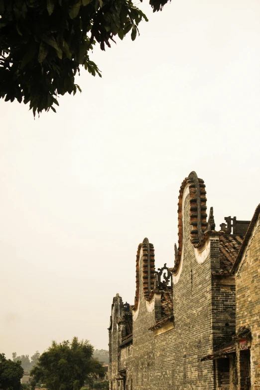 a building with a clock on the side of it, an album cover, inspired by Luis Paret y Alcazar, baroque, zhouzhuang ancient town, asymmetrical spires, shot from roofline, burned