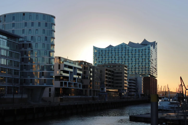 a river running through a city next to tall buildings, inspired by Emanuel Büchel, pexels contest winner, palast der republik in berlin, sunlight glistening, bjarke ingels, viewed from the harbor