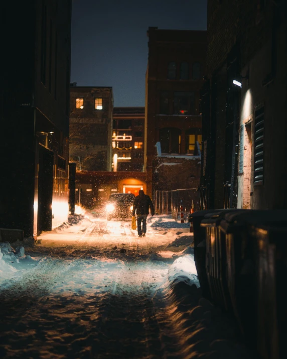 a person walking down a snowy street at night, alleys, downtown, unsplash photography, multiple stories