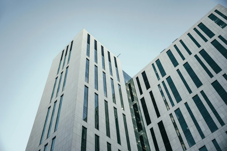 a couple of tall buildings sitting next to each other, a photo, unsplash, brutalism, reykjavik junior college, square lines, thumbnail, high quality photo