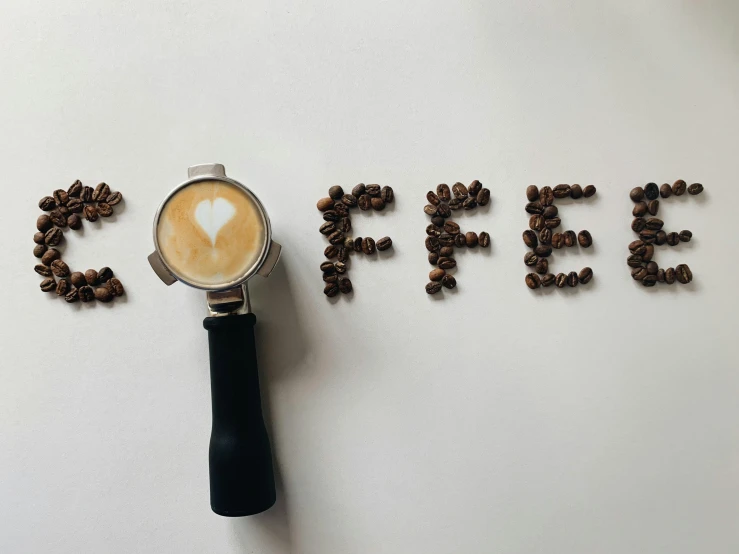 a cup of coffee next to the word coffee, by Gavin Hamilton, pexels contest winner, 🦩🪐🐞👩🏻🦳, beans, opening, ad image
