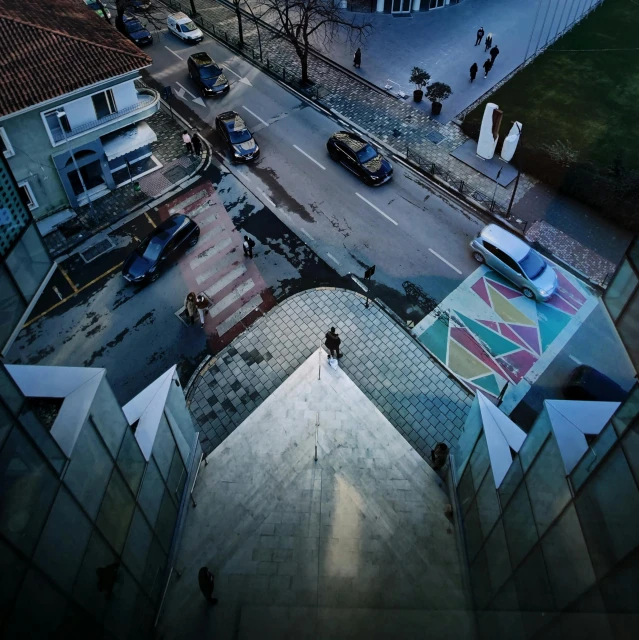 a view of a street from the top of a building, an album cover, by Ibrahim Kodra, pexels contest winner, movie still 8 k, geometric, people on the ground, profile picture 1024px