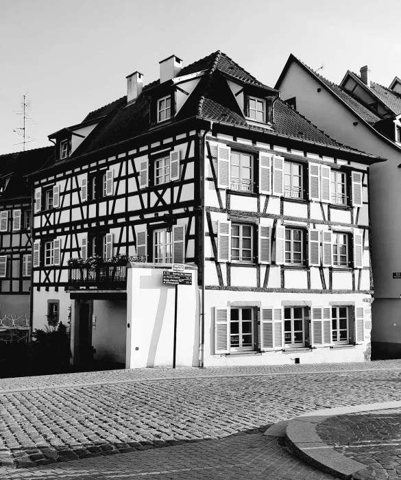 a black and white photo of a building, by Egon von Vietinghoff, medieval house, square, instagram picture, a cozy