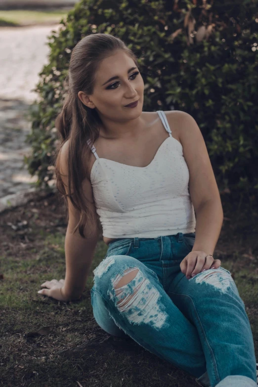 a woman sitting on the ground next to a body of water, an album cover, inspired by Elsa Bleda, trending on pexels, renaissance, outfit : jeans and white vest, headshot profile picture, teenage, wearing a crop top