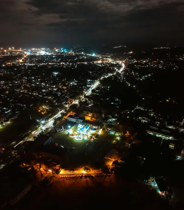 an aerial view of a city at night, hurufiyya, coban, high res 8k, journalism photo, shipibo