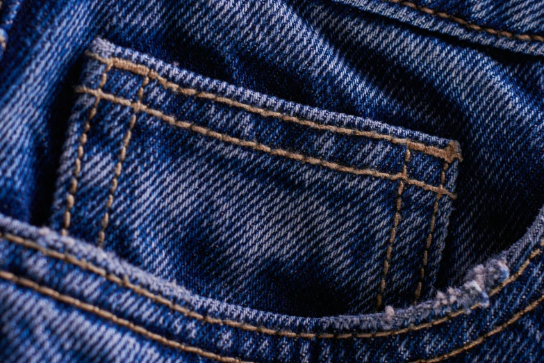 the back pocket of a pair of jeans, a macro photograph, pexels, renaissance, blue-fabric, fabrics and textiles, jean pants, mixed art