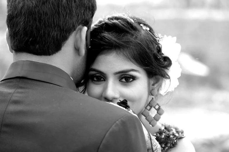 a black and white photo of a bride and groom, a black and white photo, pexels, romanticism, indian girl with brown skin, monochrome:-2, over his shoulder, cute photograph