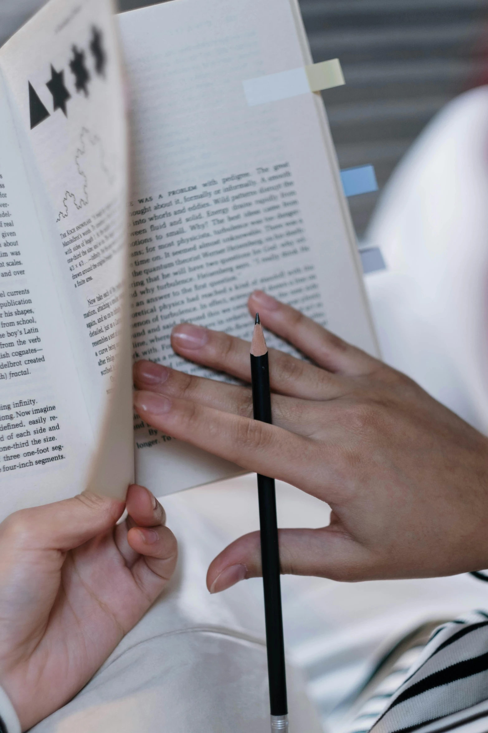 a person reading a book with a pencil in their hand, reaching out to each other, up close shot, readability, medium shot of two characters