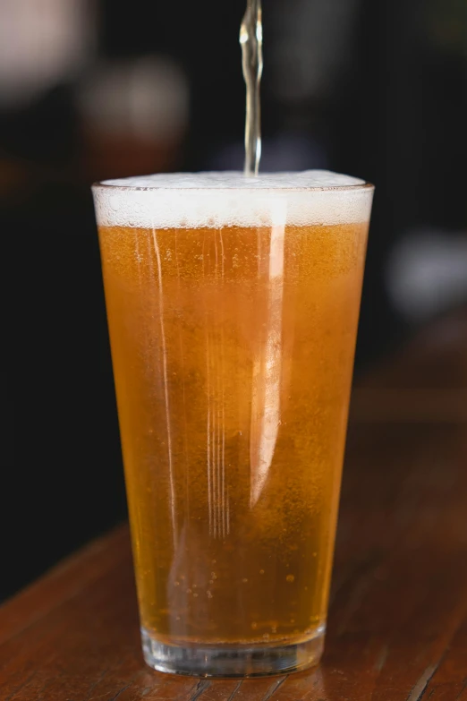 a beer being poured into a glass, by Austin English, large tall, thumbnail, abcdefghijklmnopqrstuvwxyz, hazy