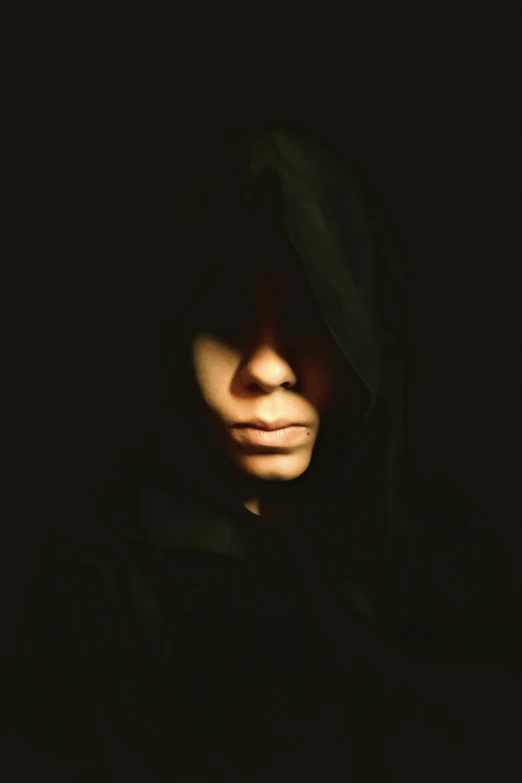 a person wearing a hoodie in the dark, an album cover, pexels, antipodeans, symmetrical portrait rpg avatar, wearing black robe, human staring blankly ahead, instagram picture