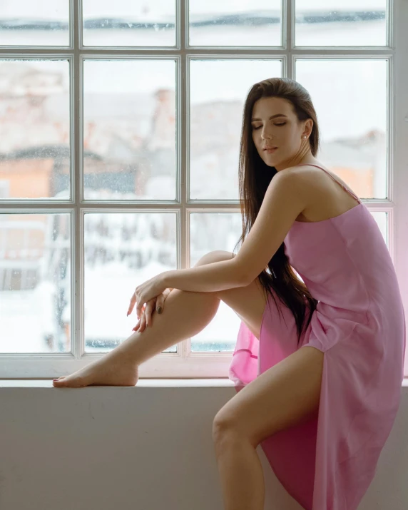 a woman in a pink dress sitting on a window sill, pexels contest winner, wearing leotard, trans rights, wearing a towel, bella poarch