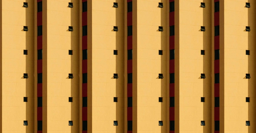 a red and black fire hydrant sitting in front of a tall building, a photo, inspired by Andreas Gursky, yellow wallpaper, house windows, suns, las vegas