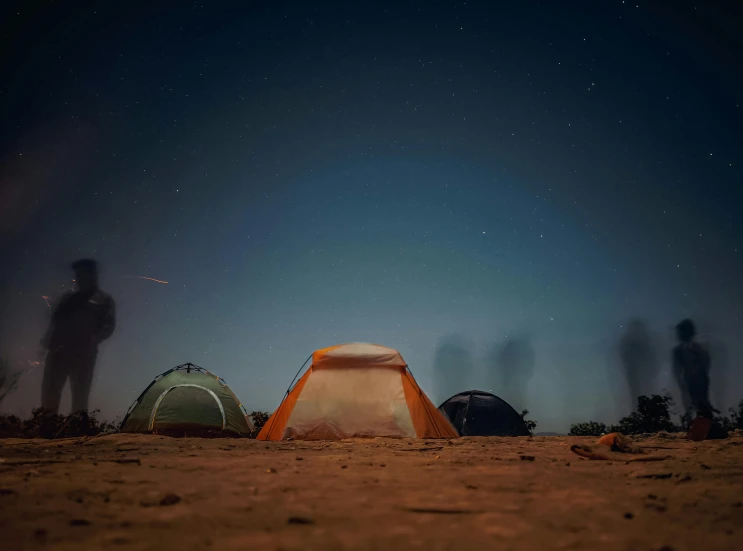 a group of people standing around a tent at night, by Julia Pishtar, unsplash contest winner, hurufiyya, dusty background, planets in the sky, rust and dust and fire and dirt, tents