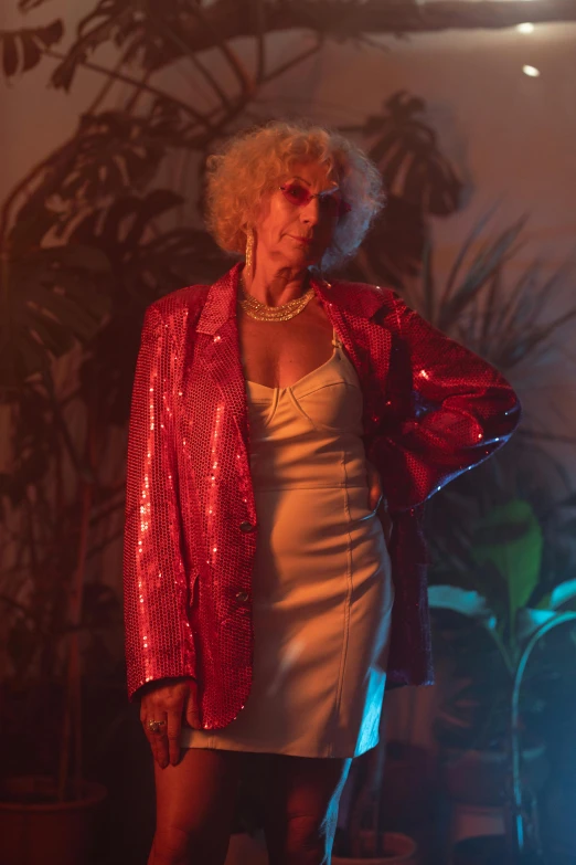 a woman in a red jacket talking on a cell phone, an album cover, inspired by Nan Goldin, pexels, renaissance, elderly greek goddess, wearing disco suit, woman posing, tall thin