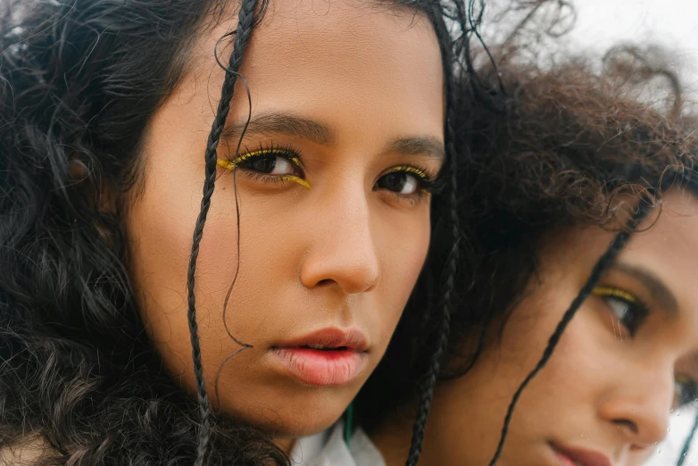 a couple of women standing next to each other, trending on pexels, hyperrealism, yellow makeup, mixed race, black and gold wires, teenage girl